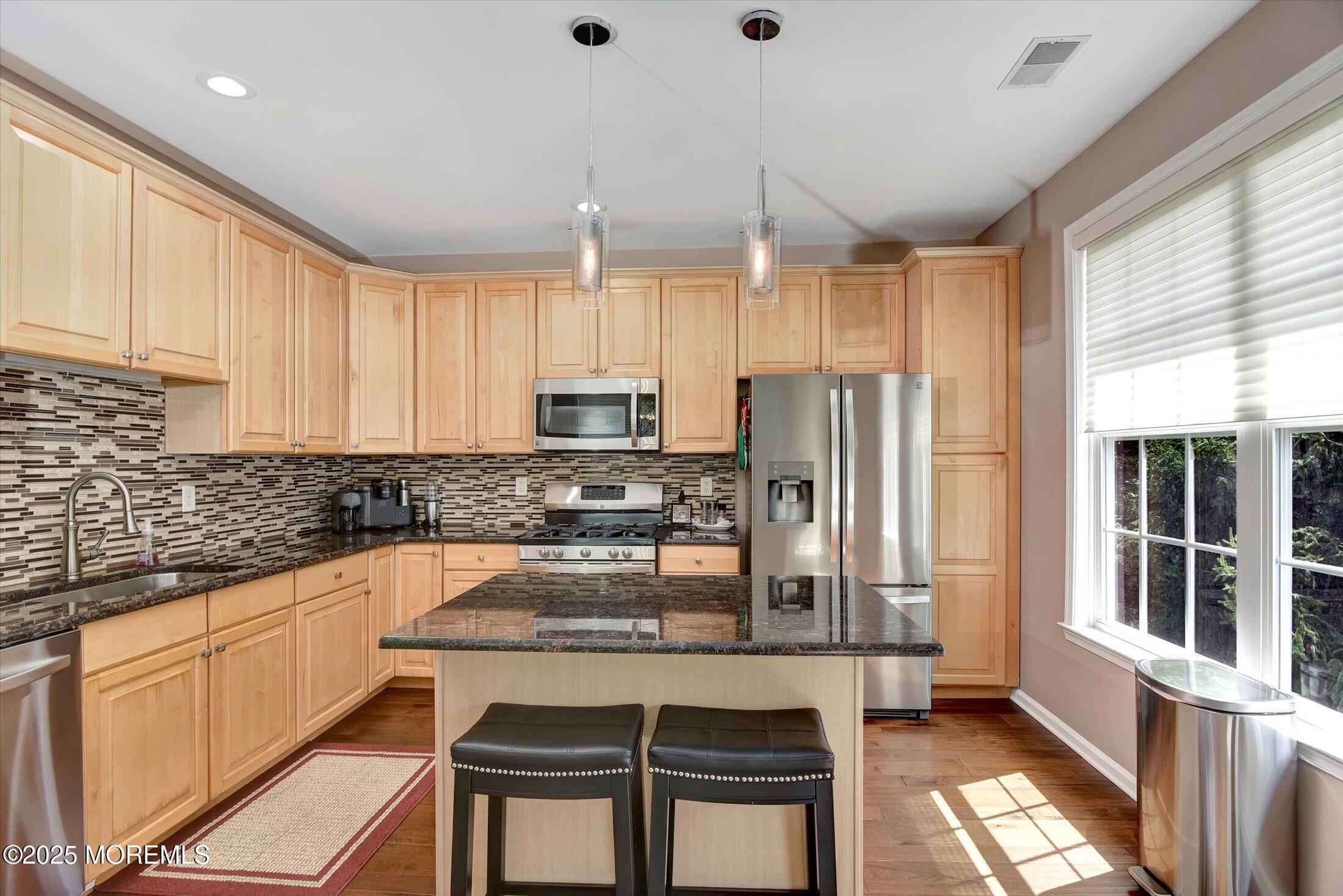 594 St Andrews Place Manalapan, NJ 07726 - Photo 4 of 35 a kitchen with stainless steel appliances granite countertop a stove a sink and a refrigerator
