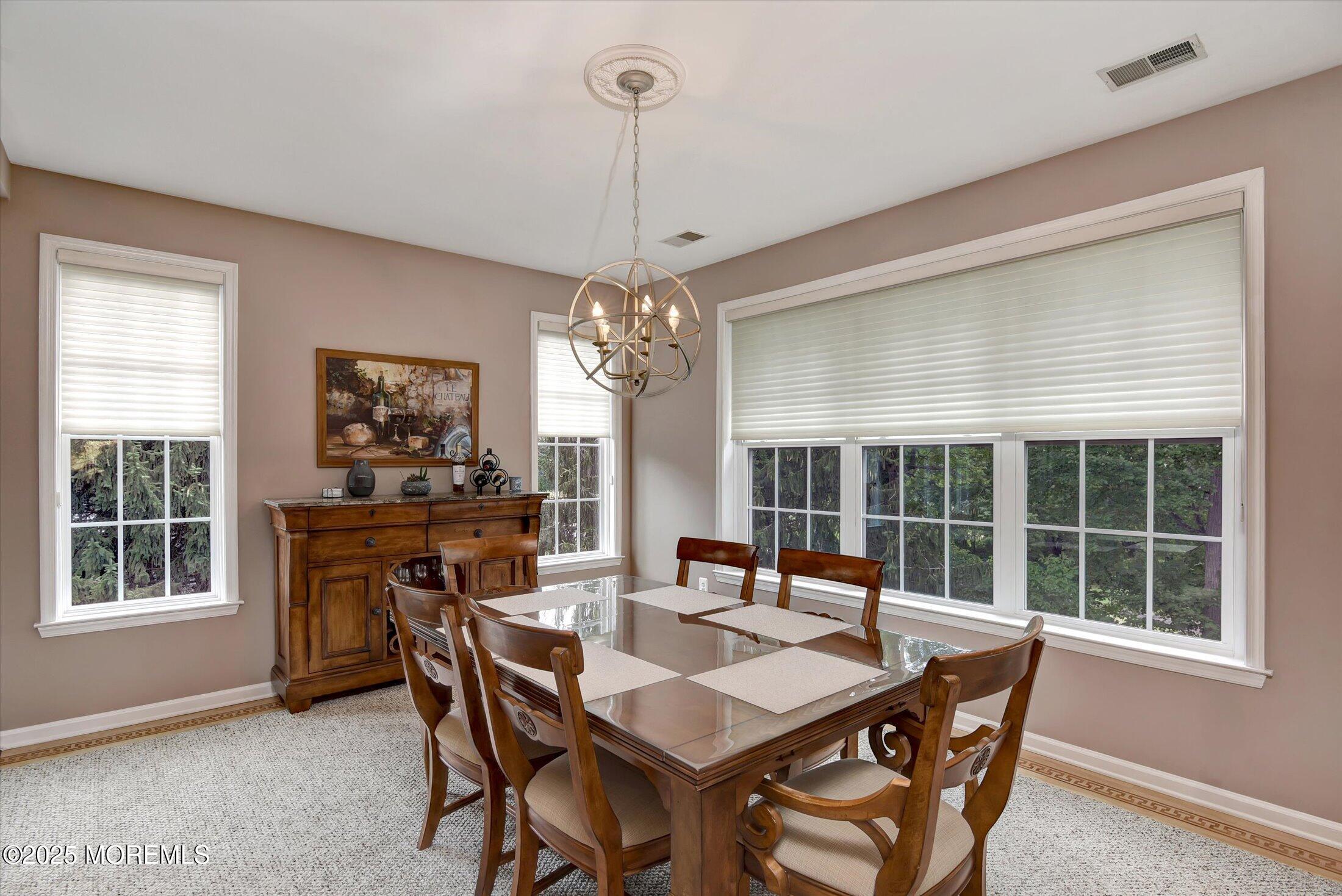594 St Andrews Place Manalapan, NJ 07726 - Photo 8 of 35 a dining room with furniture a chandelier and window