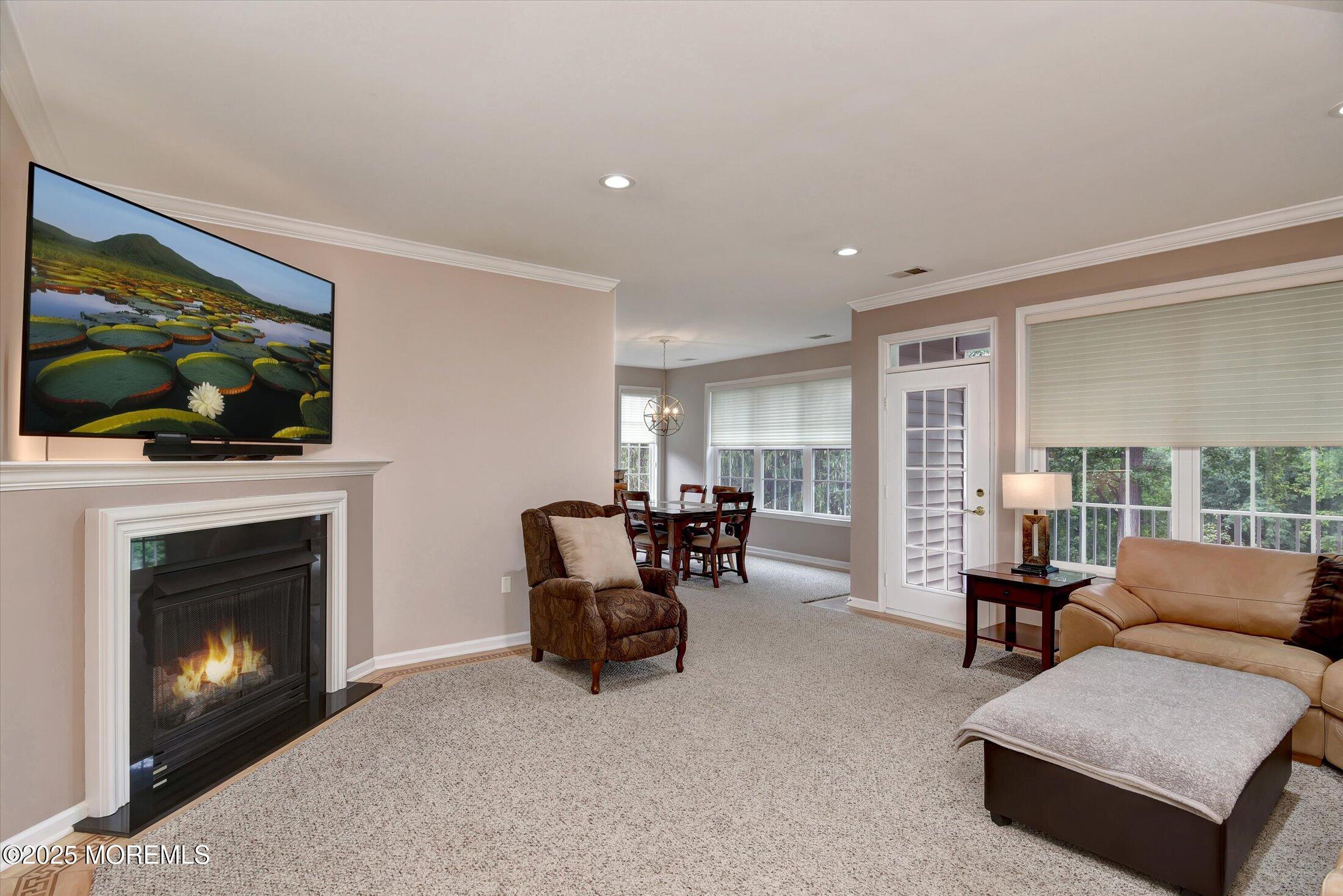 594 St Andrews Place Manalapan, NJ 07726 - Photo 9 of 35 a living room with furniture and a fireplace