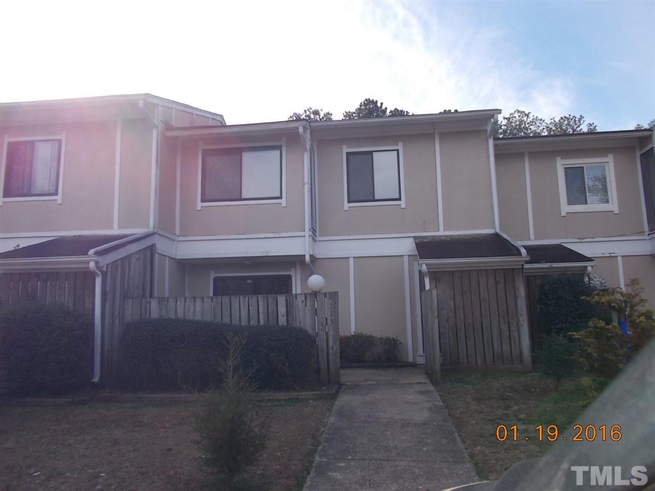4313 Lake Ridge Drive, Unit 9E Raleigh, NC 27604 - Photo 1 of 16 a front view of a house with a tree
