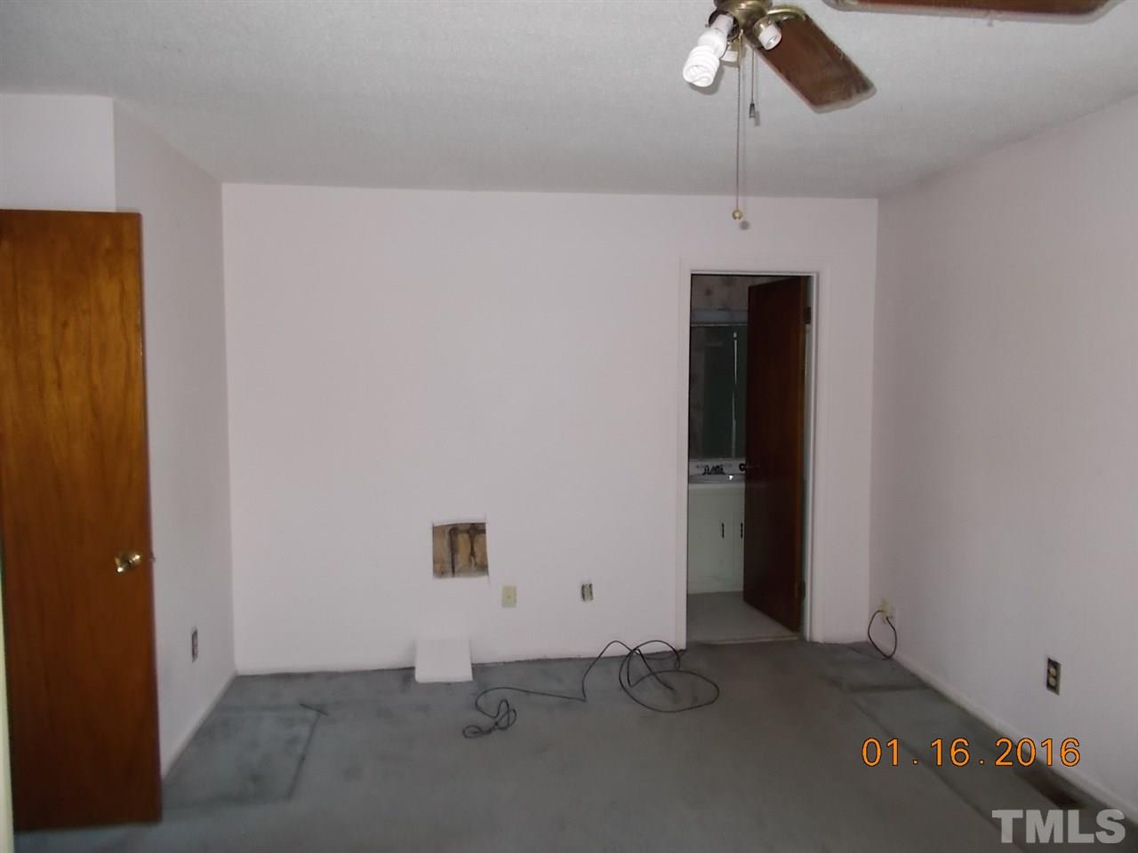 4313 Lake Ridge Drive, Unit 9E Raleigh, NC 27604 - Photo 14 of 16 an empty room with ceiling fan