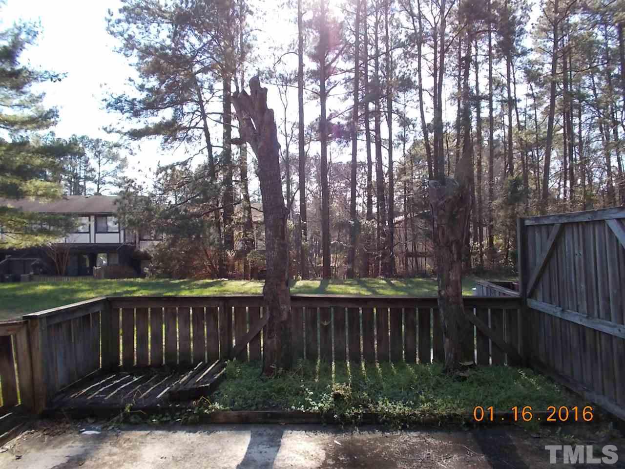 4313 Lake Ridge Drive, Unit 9E Raleigh, NC 27604 - Photo 4 of 16 a view of backyard with wooden fence and large trees