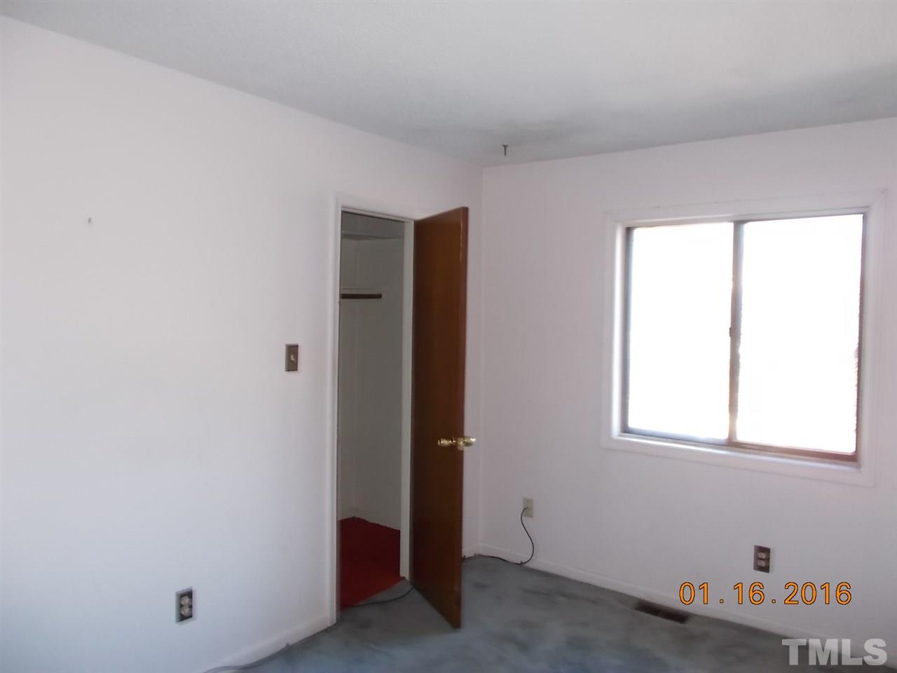 4313 Lake Ridge Drive, Unit 9E Raleigh, NC 27604 - Photo 7 of 16 an empty room with a window