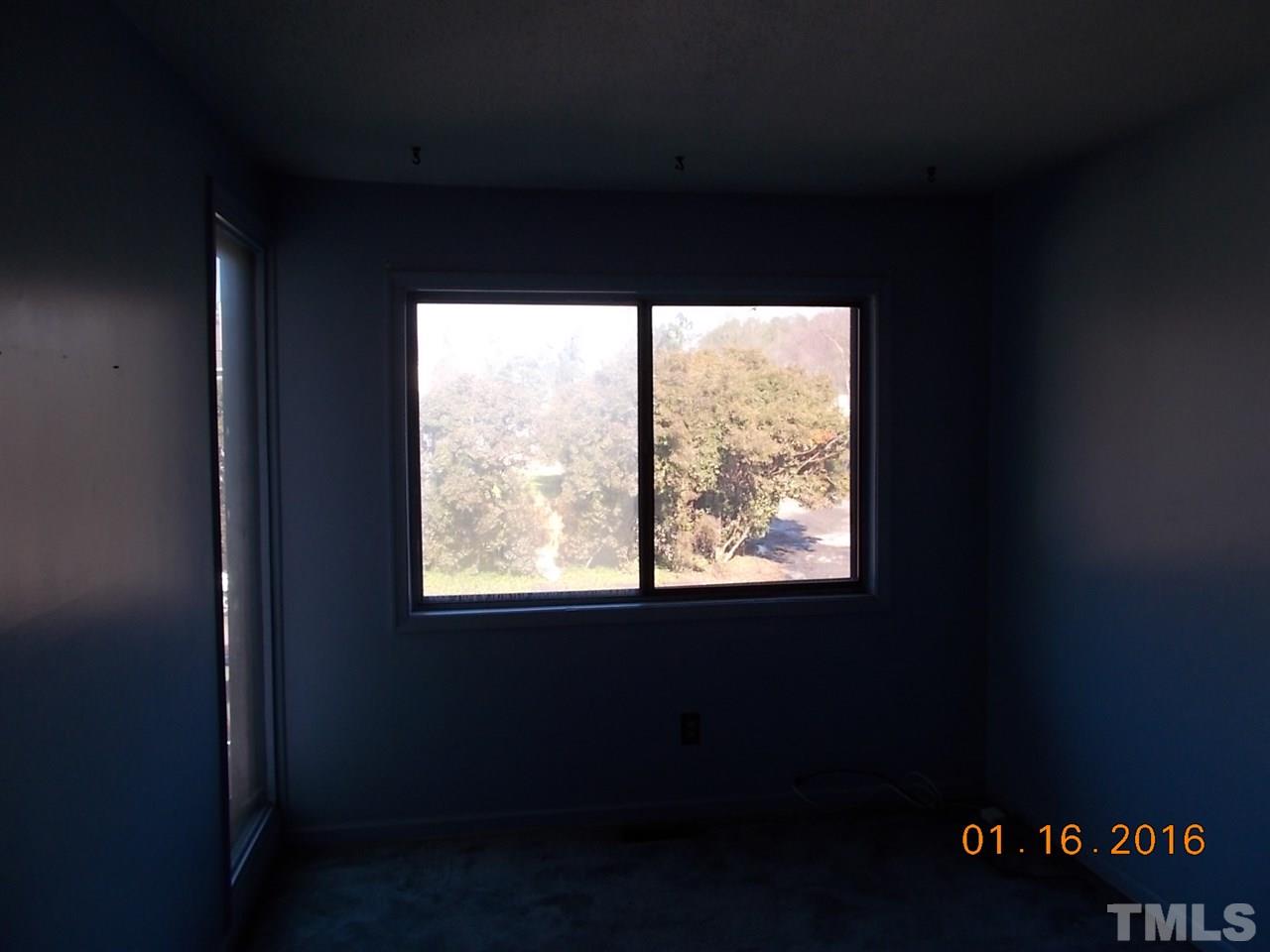4313 Lake Ridge Drive, Unit 9E Raleigh, NC 27604 - Photo 10 of 16 a close view of an empty room with a window