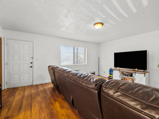 460 200 South Provo, UT 84606 - Photo 32 of 66 Living area featuring dark wood-type flooring and a textured ceiling
