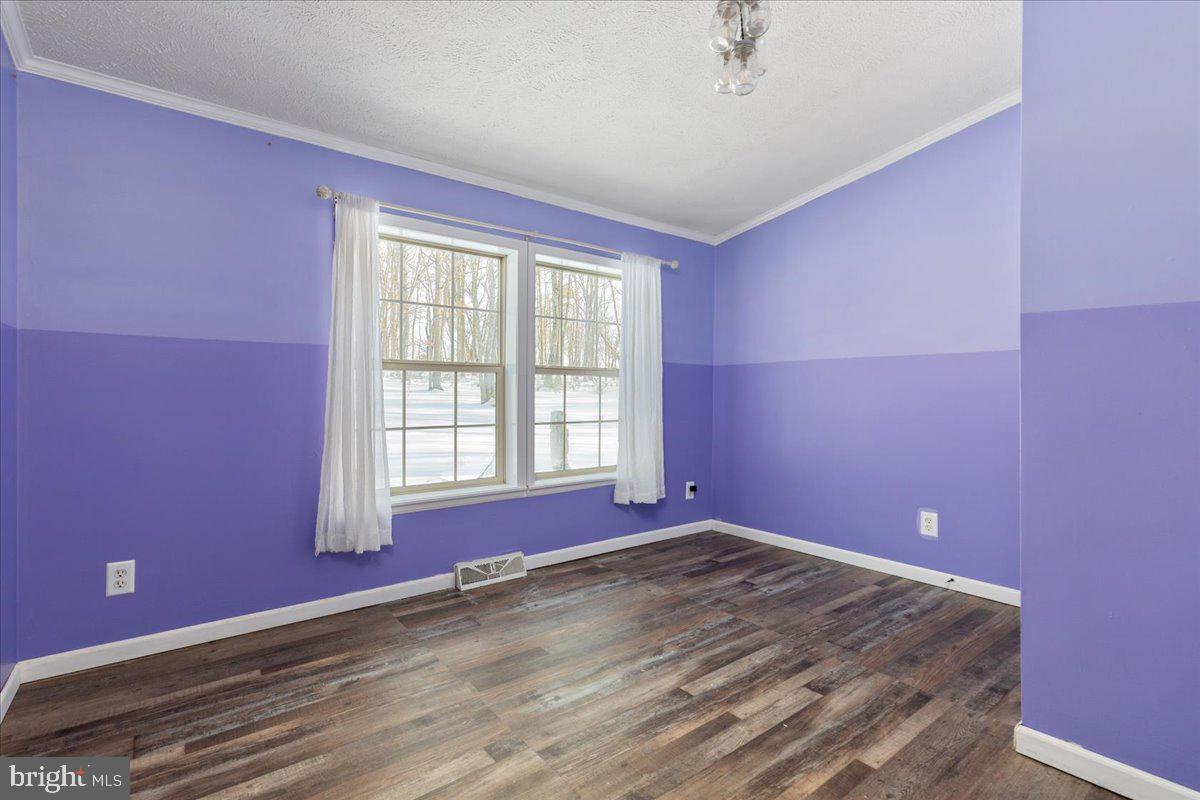 1501 South Timber Ridge Road Cross Junction, VA 22625 - Photo 14 of 66 a view of empty room with wooden floor and fan