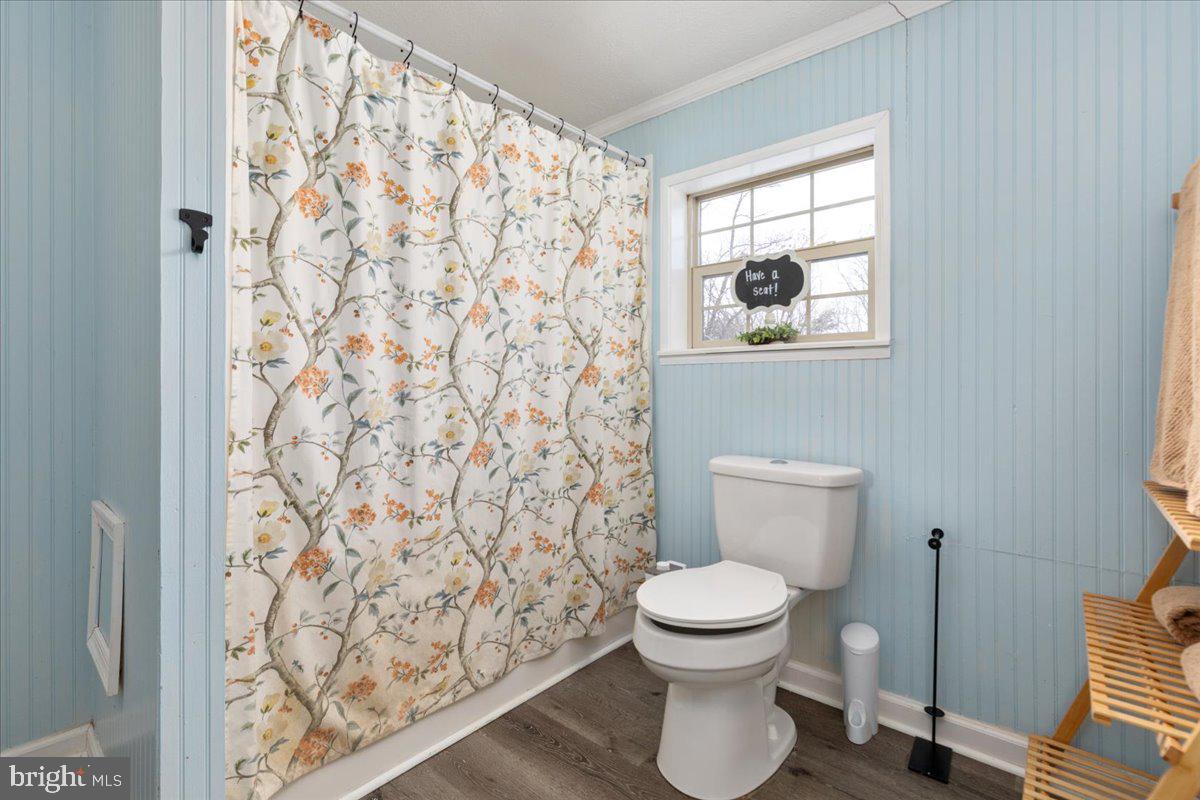 1501 South Timber Ridge Road Cross Junction, VA 22625 - Photo 15 of 66 a white toilet sitting next to a shower curtain