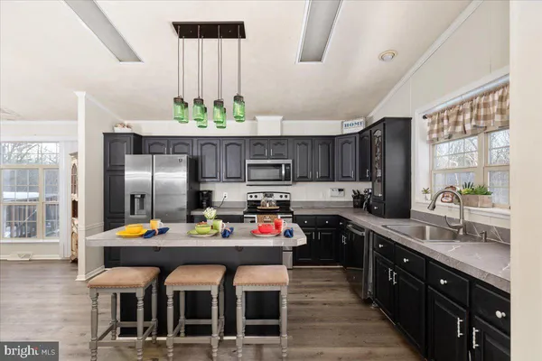a kitchen with stainless steel appliances a sink stove and refrigerator