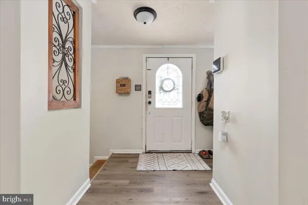a view of a hallway with wooden floor