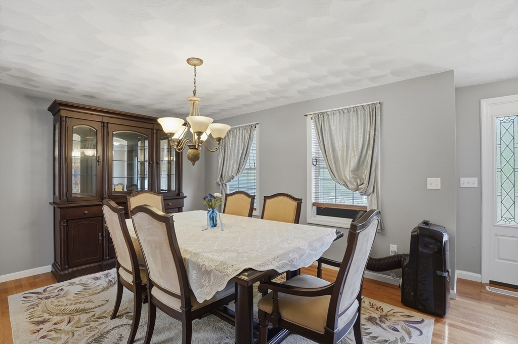 160 Gray Road Templeton, MA 01468 - Photo 15 of 42 a dining room with furniture a chandelier and wooden floor