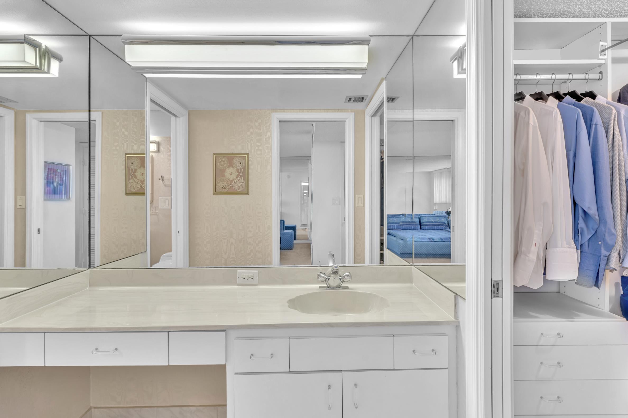 900 Northeast Spanish River Boulevard, Unit 4E Boca Raton, FL 33431 - Photo 16 of 26 a bathroom with a sink and a mirror