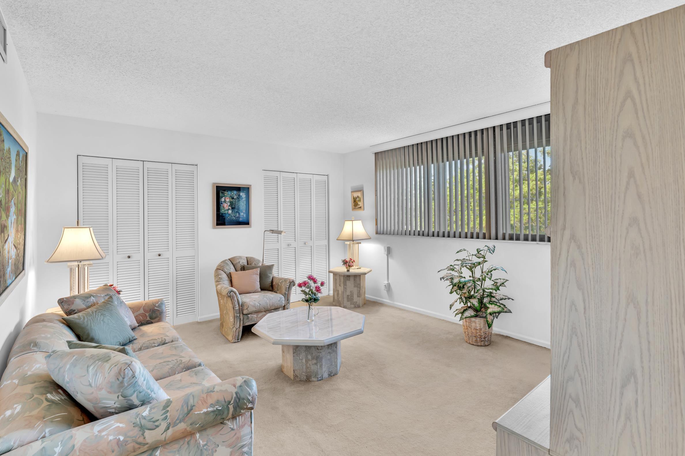 900 Northeast Spanish River Boulevard, Unit 4E Boca Raton, FL 33431 - Photo 17 of 26 a living room with furniture and a potted plant