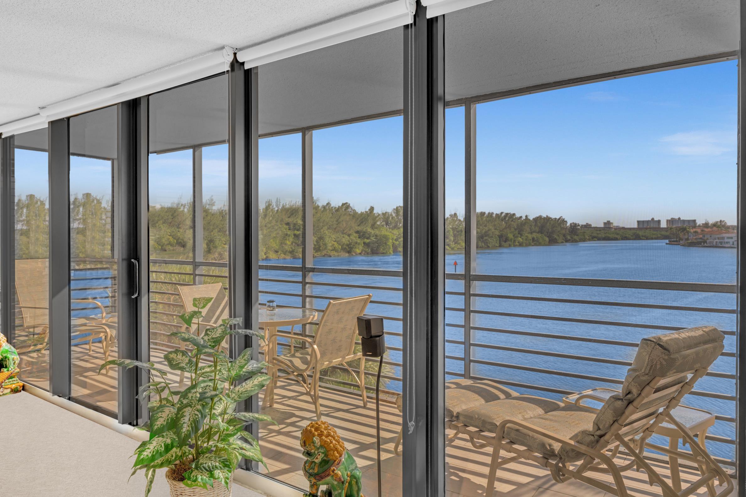 900 Northeast Spanish River Boulevard, Unit 4E Boca Raton, FL 33431 - Photo 20 of 26 a view of a balcony with lake view and a floor to ceiling window
