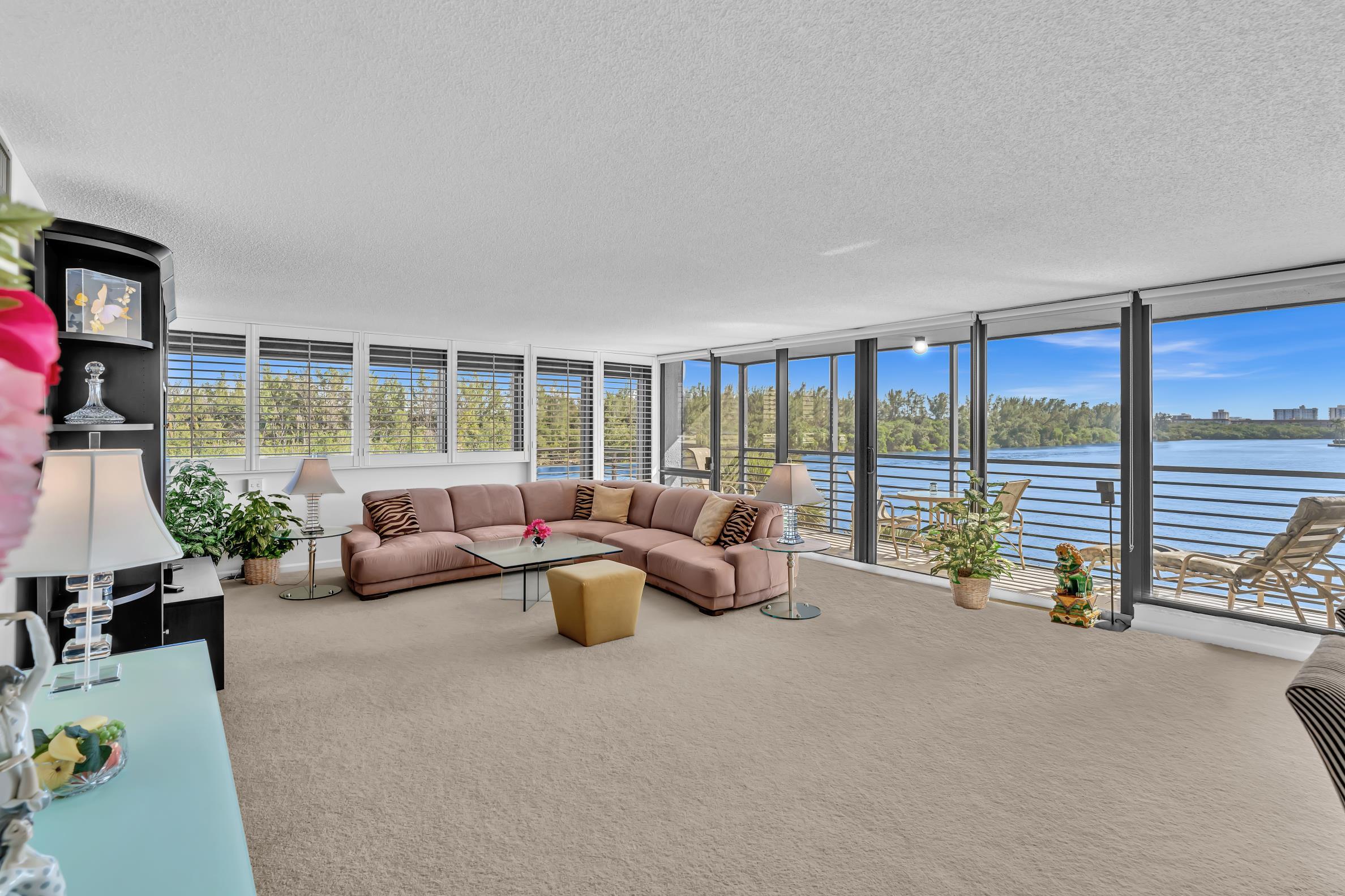 900 Northeast Spanish River Boulevard, Unit 4E Boca Raton, FL 33431 - Photo 7 of 26 a living room with furniture and a large window