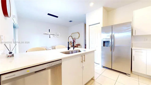 a kitchen with a sink and a refrigerator