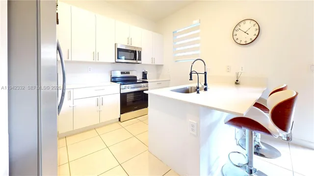 a kitchen with stainless steel appliances granite countertop a sink and a stove