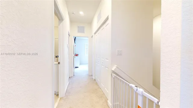 a view of a hallway with a white walls
