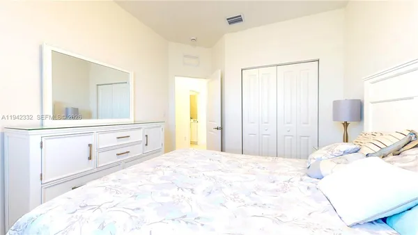 a bedroom with a bed and a mirror