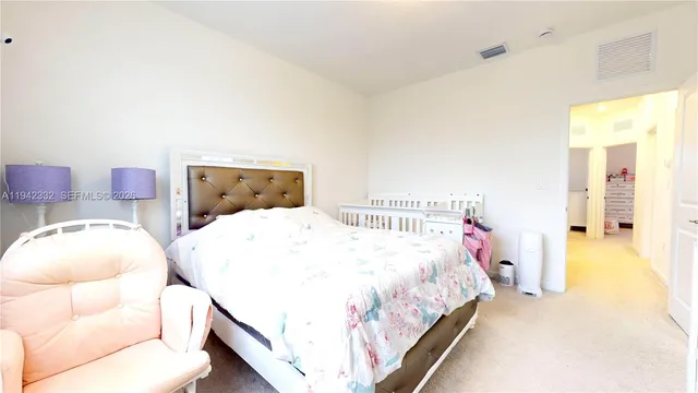 a bedroom with two beds and painted walls