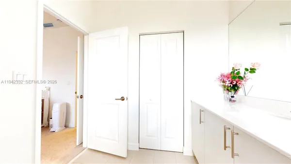 a bathroom with a shower sink and a mirror