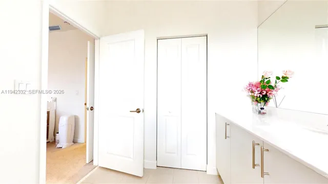 a bathroom with a shower sink and a mirror