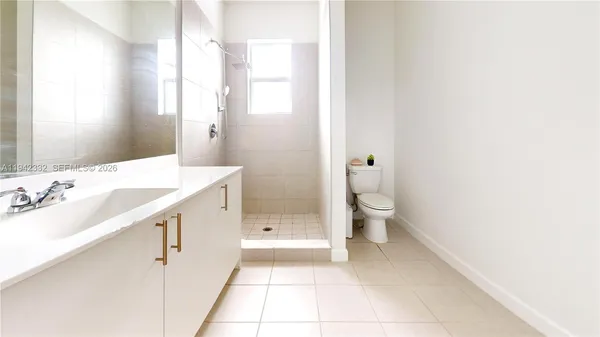 a bathroom with a double vanity sink toilet and shower