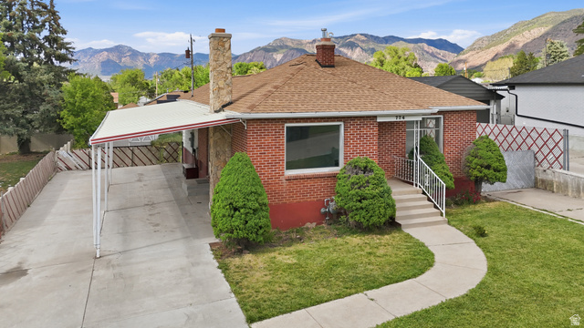 774 37th Street South Ogden, UT 84403 - Photo 42 of 47 Brick exterior residence featuring a brown shingle roof, a covered carport, and a concrete pathway leading to the front entry