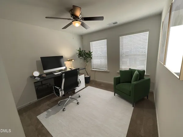 a livingroom with workspace and a window