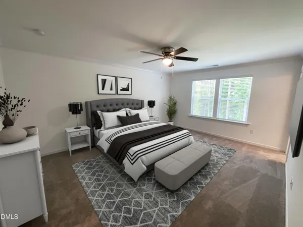 a spacious bedroom with a bed and a window