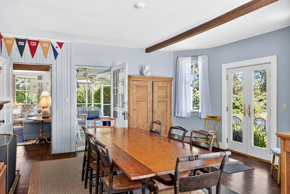 250 Scraggy Neck Road Cataumet, MA 02534 - Photo 14 of 86 a view of a dining room with furniture window and wooden floor