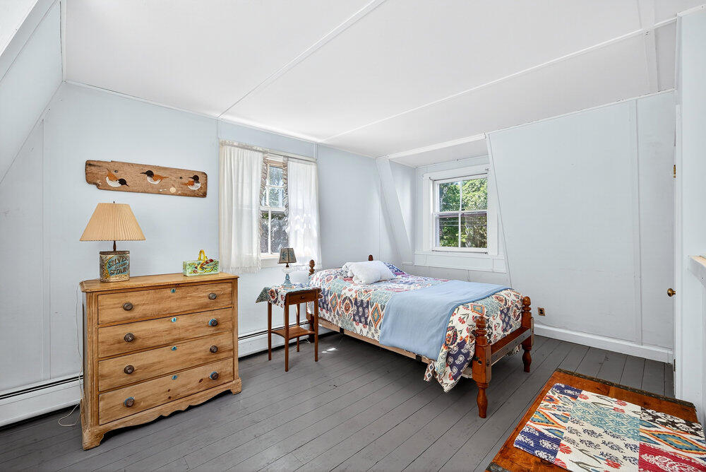 250 Scraggy Neck Road Cataumet, MA 02534 - Photo 34 of 86 a bedroom with a bed and a dresser
