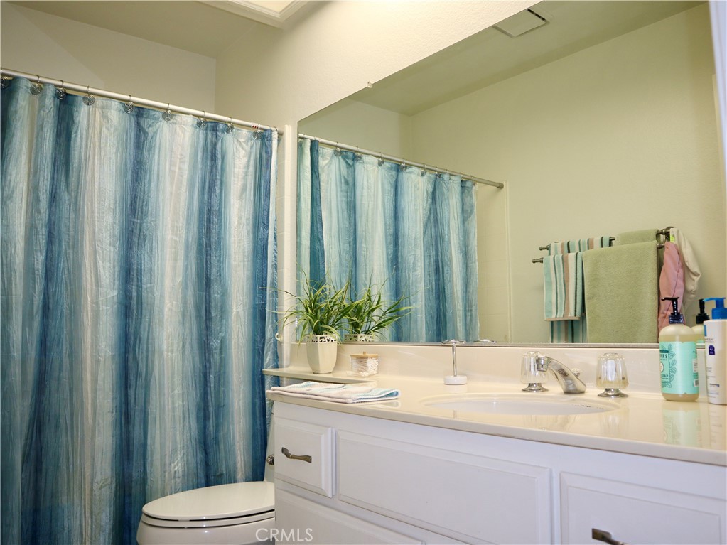 21475 Dickinson Road Moreno Valley, CA 92557 - Photo 24 of 41 a bathroom with a granite countertop sink and a mirror