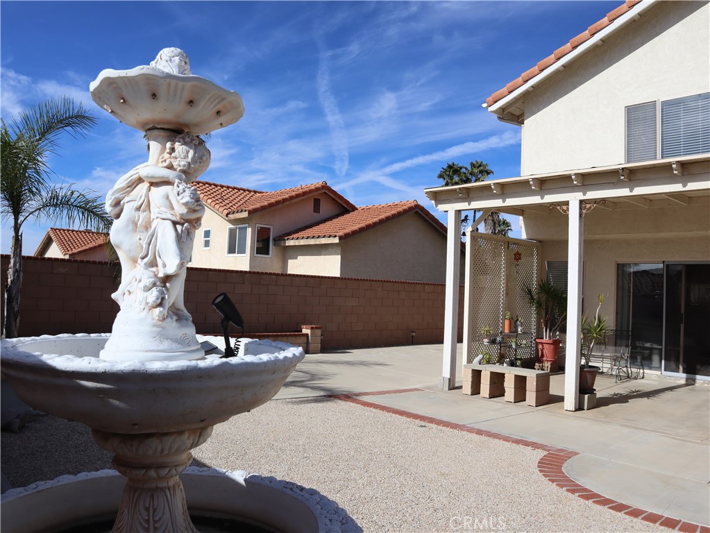 21475 Dickinson Road Moreno Valley, CA 92557 - Photo 40 of 41 a side view of a house with table and chairs