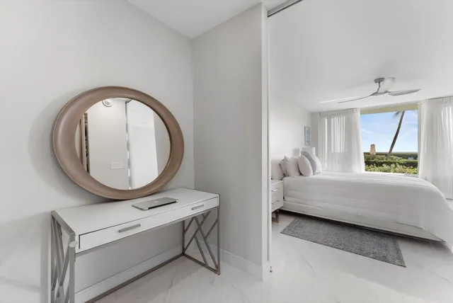 a room with a bed and a mirror