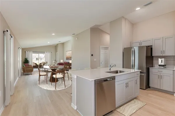 a kitchen with white cabinets and stainless steel appliances
