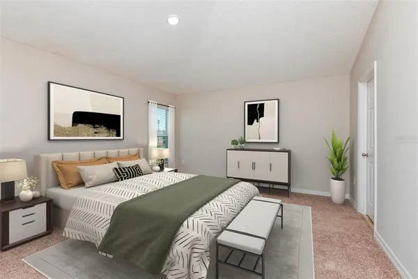 a bedroom with a large bed and a potted plant