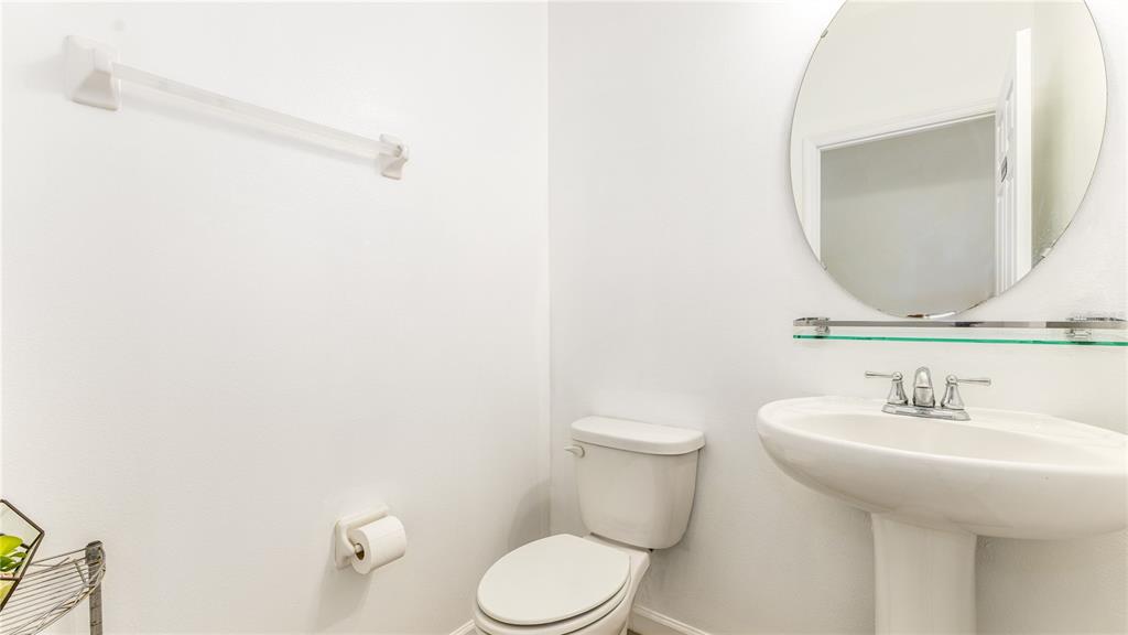 1723 Musgrass Circle Melbourne, FL 32904 - Photo 18 of 31 a bathroom with a toilet sink and mirror