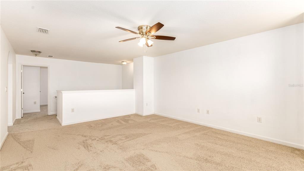 1723 Musgrass Circle Melbourne, FL 32904 - Photo 21 of 31 a view of a room with a ceiling fan