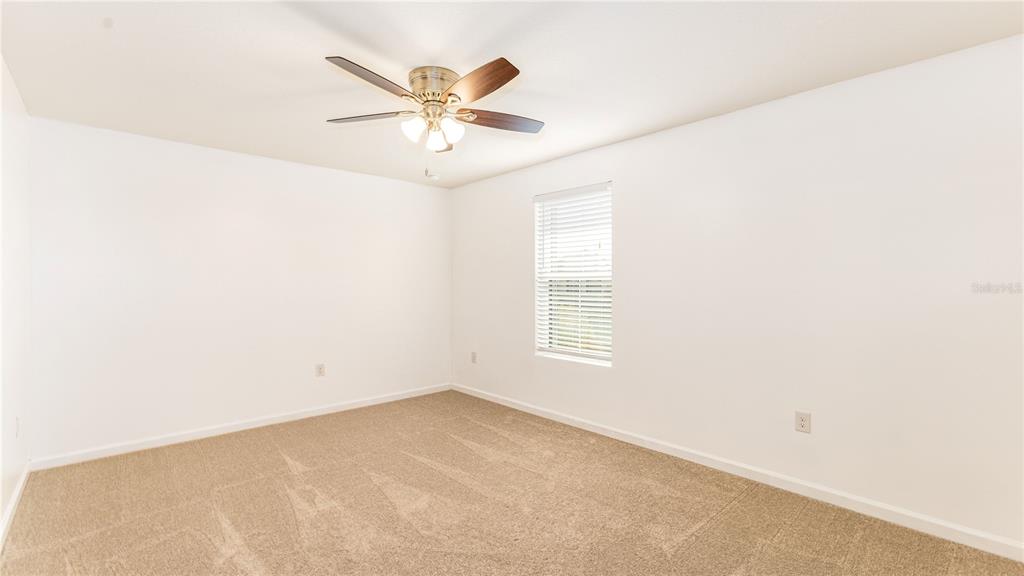 1723 Musgrass Circle Melbourne, FL 32904 - Photo 23 of 31 an empty room with a window and a fan