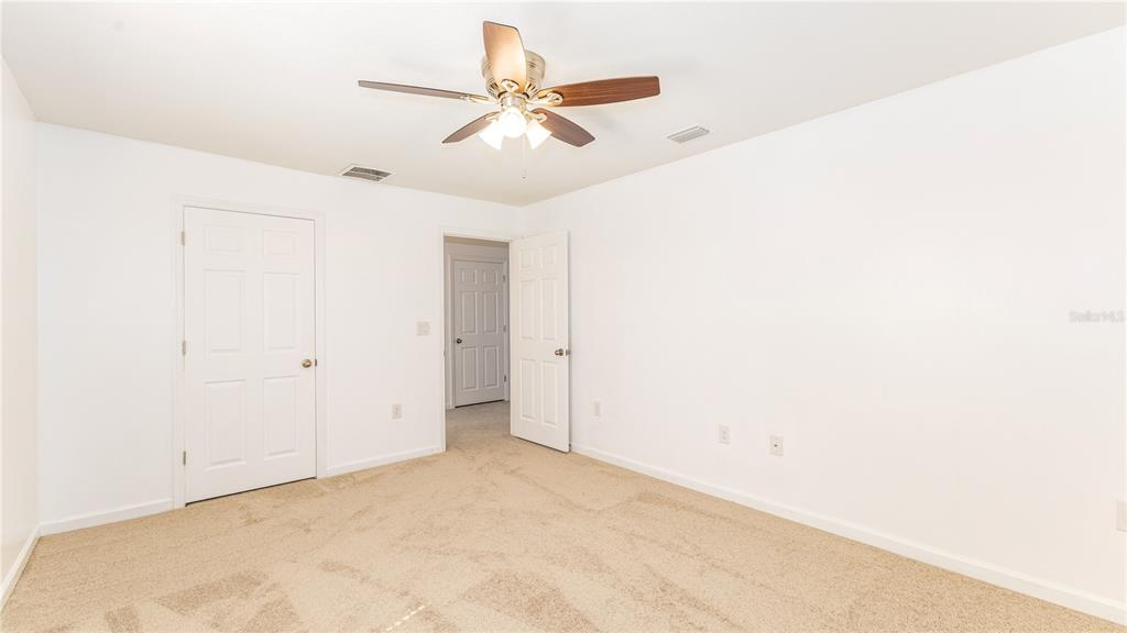 1723 Musgrass Circle Melbourne, FL 32904 - Photo 24 of 31 an empty room with a ceiling fan and a window