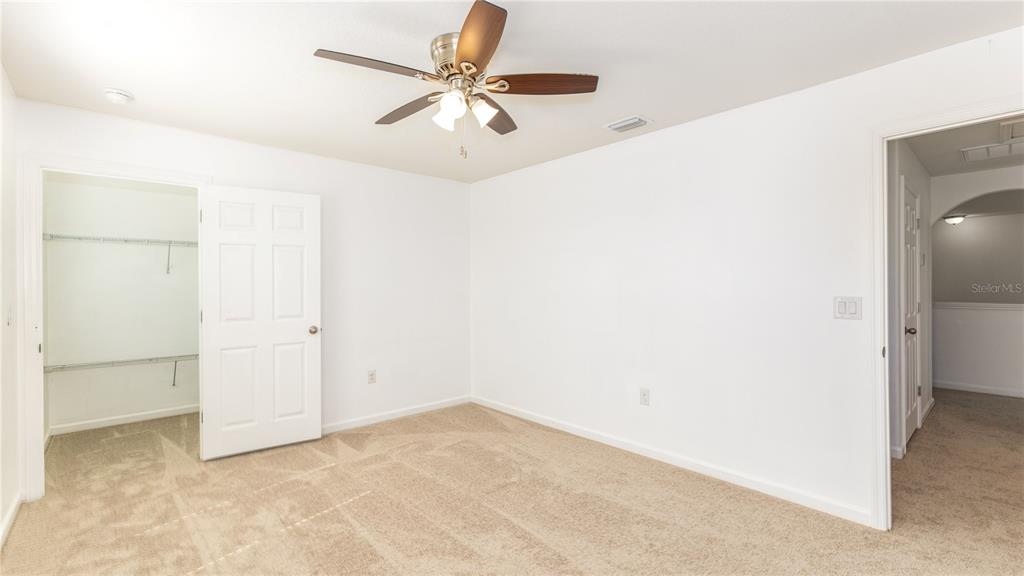1723 Musgrass Circle Melbourne, FL 32904 - Photo 26 of 31 an empty room with a ceiling fan and a window