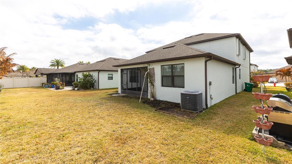 1723 Musgrass Circle Melbourne, FL 32904 - Photo 28 of 31 a view of a house with backyard and a tree