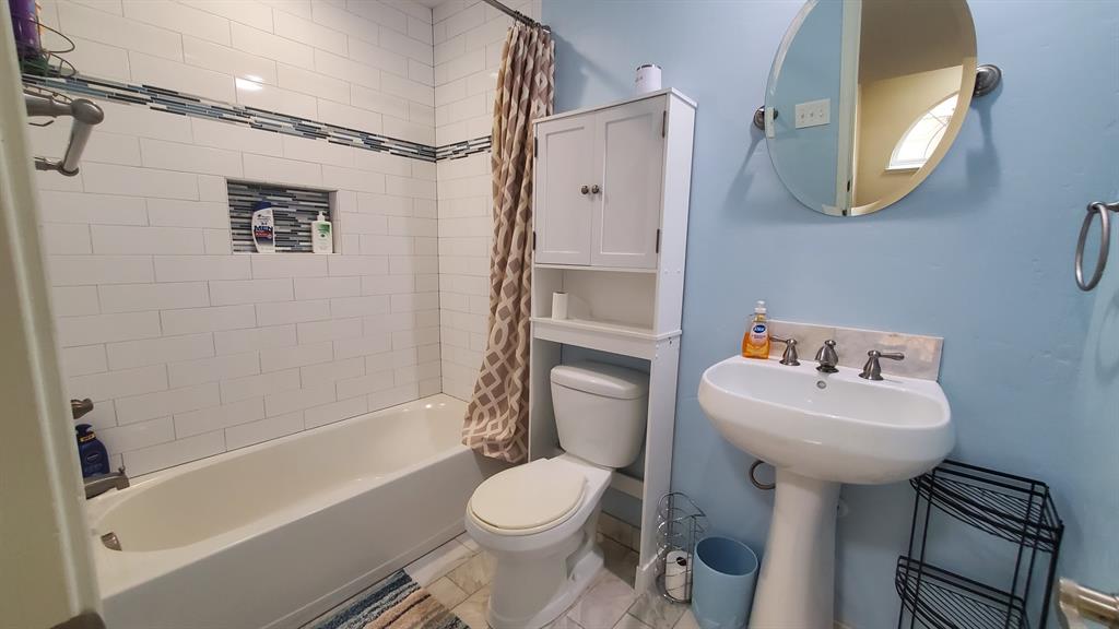 2413 Autumndale Drive Mesquite, TX 75150 - Photo 11 of 14 a bathroom with a sink toilet and shower