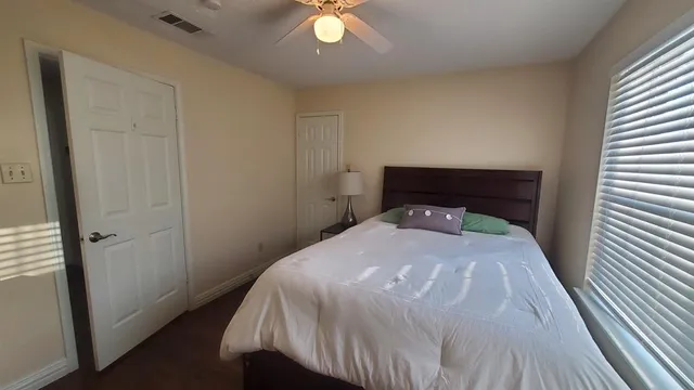 a bedroom with a bed and a window