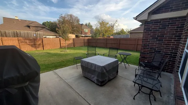 a backyard of a house with table and chairs