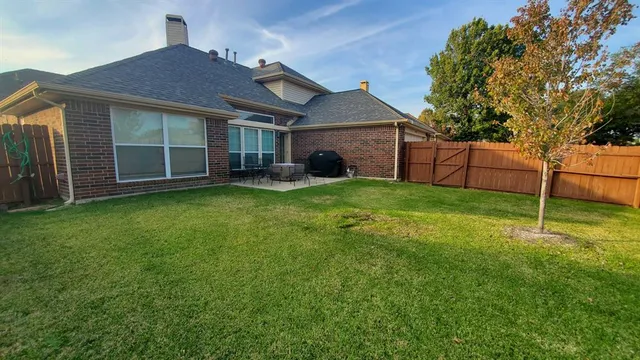 a view of a house with a yard and sitting area