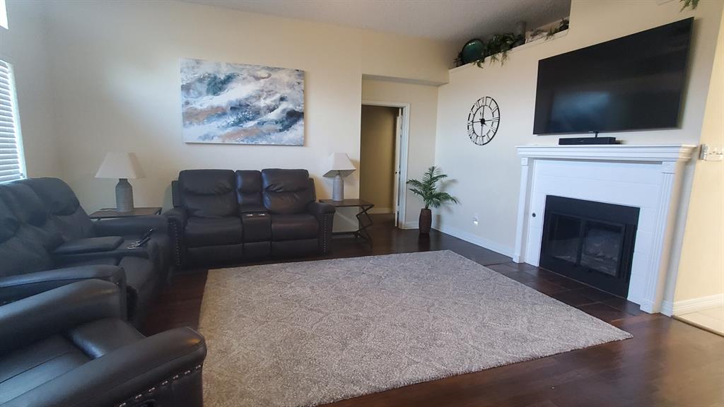 2413 Autumndale Drive Mesquite, TX 75150 - Photo 2 of 14 a living room with furniture and a fireplace
