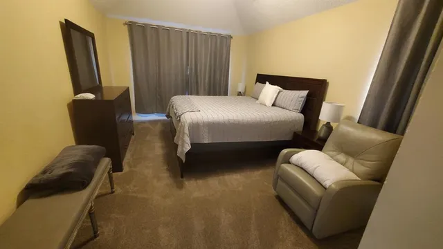 a bedroom with a bed chair and a couch