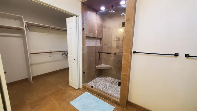 a bathroom with a shower and a toilet