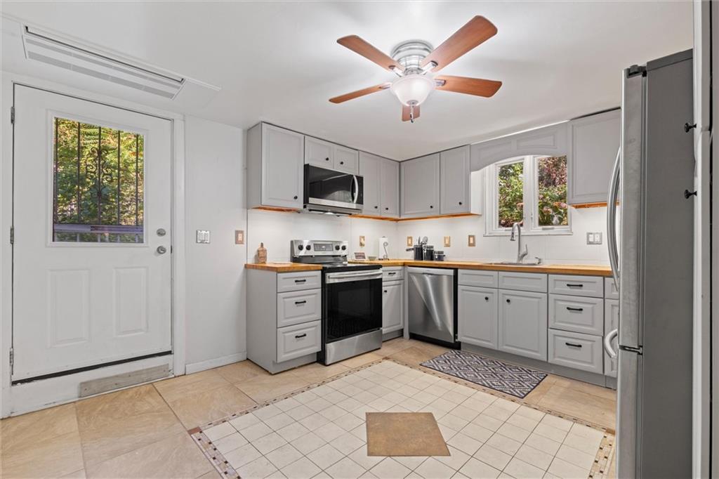 520 Knoll Street Pittsburgh, PA 15212 - Photo 13 of 47 a kitchen with a stove a sink and a refrigerator